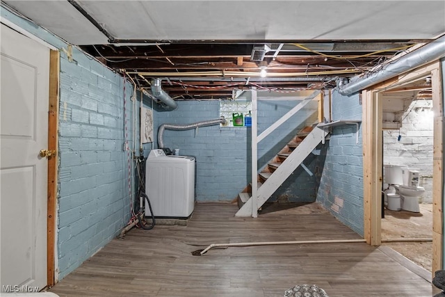 basement featuring washer / clothes dryer and hardwood / wood-style flooring