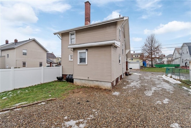 back of house with a garage