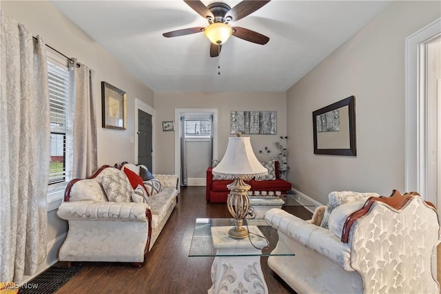 living room featuring dark hardwood / wood-style floors and ceiling fan