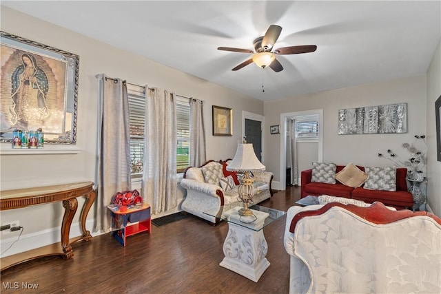 bedroom featuring ceiling fan, dark hardwood / wood-style flooring, and multiple windows