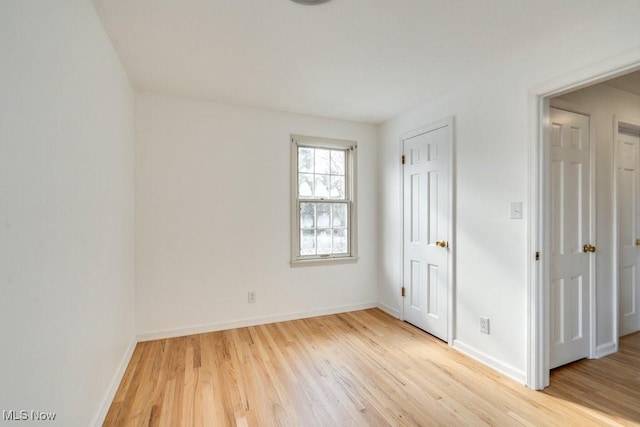 unfurnished bedroom with light wood-style floors and baseboards