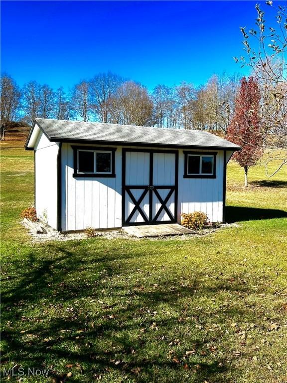 view of outbuilding with a lawn