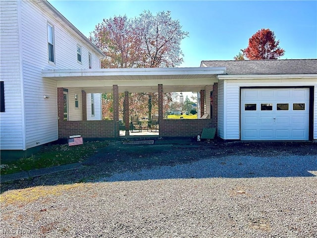 view of front of property featuring a garage and a carport