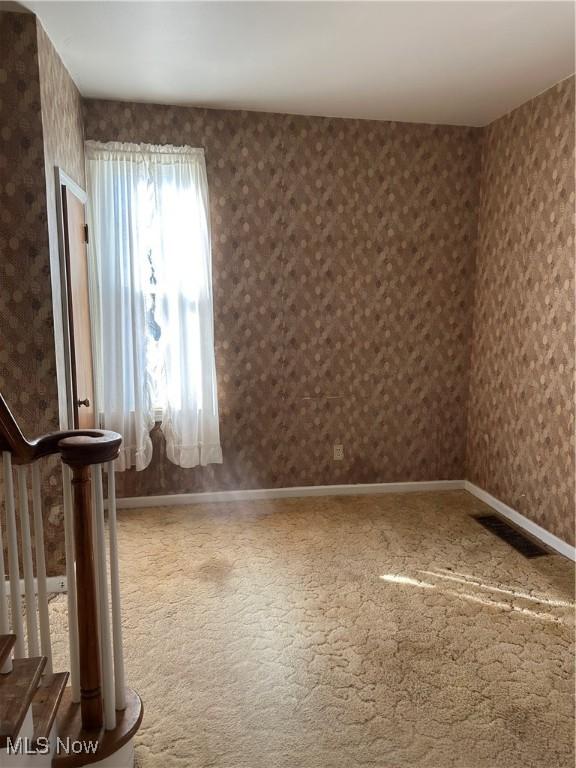 unfurnished room featuring carpet