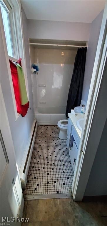 full bathroom featuring a baseboard radiator, vanity, toilet, and shower / bath combo