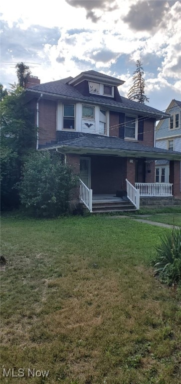 view of front of home with a front yard and a porch