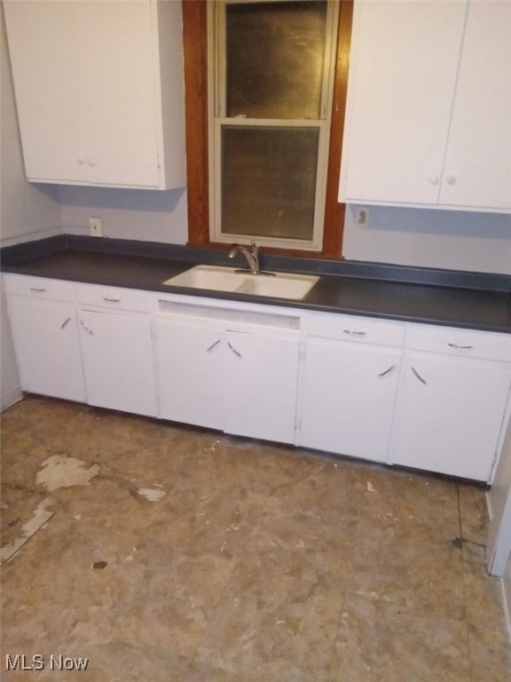 kitchen featuring sink and white cabinets