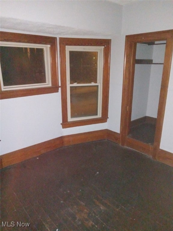 empty room with hardwood / wood-style floors