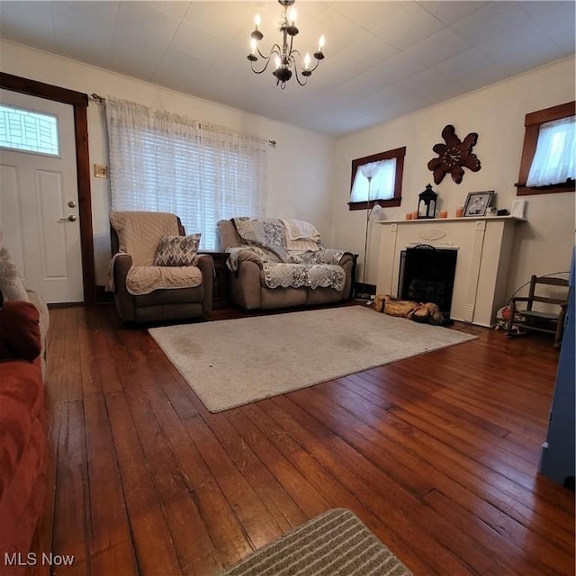 living room with a notable chandelier and dark hardwood / wood-style floors