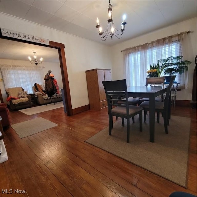 dining room with an inviting chandelier and hardwood / wood-style flooring