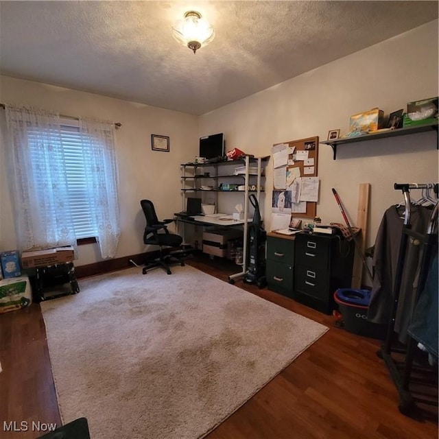 home office with hardwood / wood-style floors and a textured ceiling