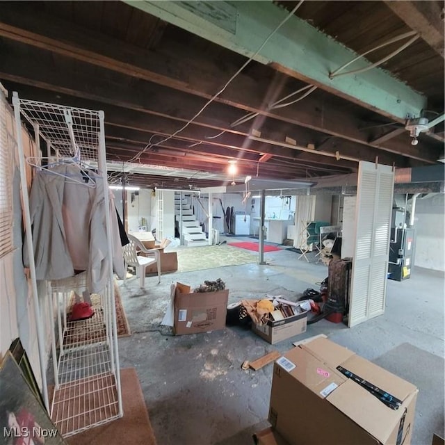 basement with washer and clothes dryer and heating unit