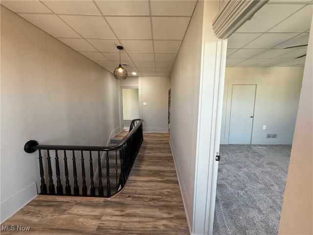 hall featuring hardwood / wood-style flooring and a drop ceiling