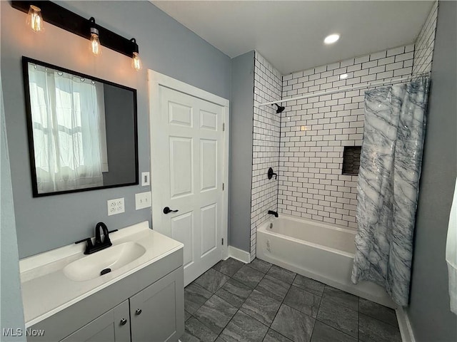 bathroom featuring vanity and shower / bath combination with curtain