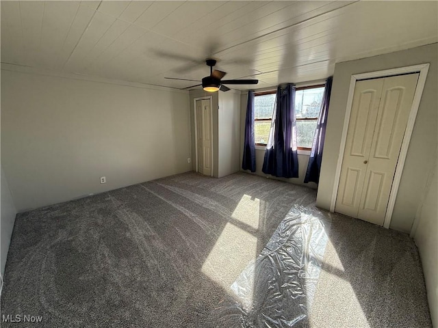 unfurnished bedroom with ceiling fan, carpet floors, and wooden ceiling