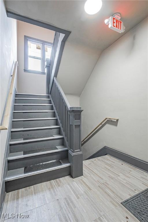 stairs featuring lofted ceiling