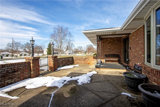 view of patio with a gate and fence