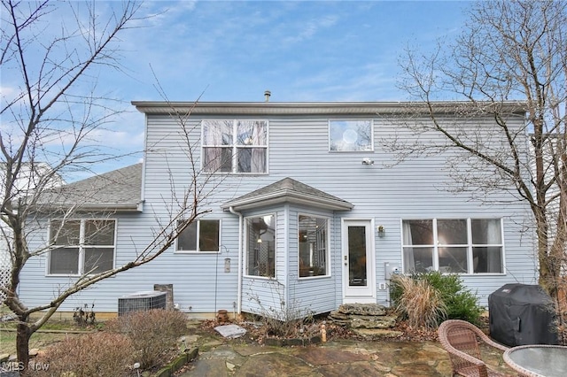 rear view of house featuring a patio area and central air condition unit