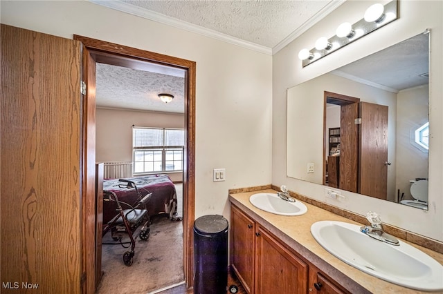 bathroom with vanity, ornamental molding, and a textured ceiling