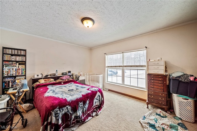 bedroom featuring ornamental molding, carpet floors, and a textured ceiling