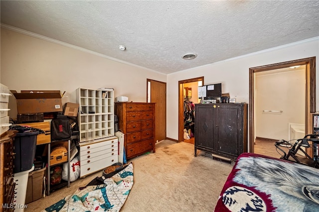 bedroom with light colored carpet, ornamental molding, and a textured ceiling