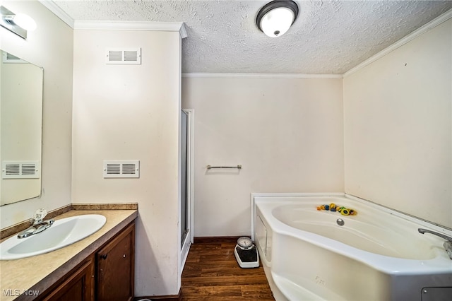 bathroom with wood-type flooring, ornamental molding, and a bathing tub