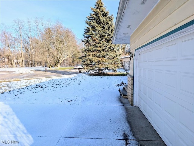 yard covered in snow with a garage