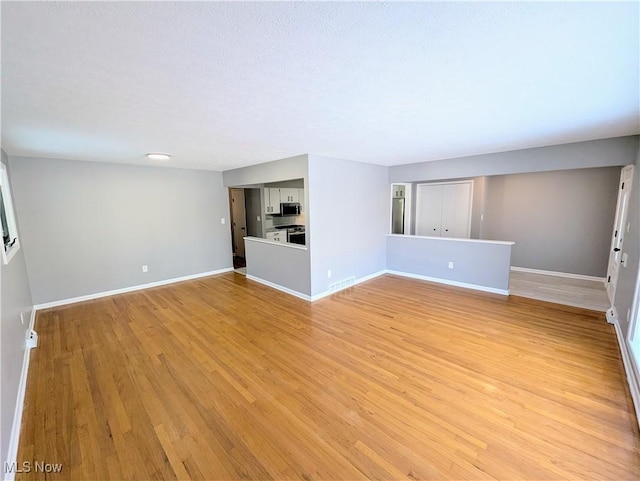 unfurnished living room with light wood-type flooring