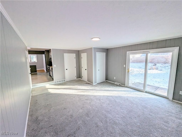 carpeted spare room featuring a healthy amount of sunlight