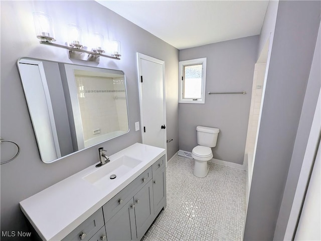 bathroom with tile patterned flooring, vanity, and toilet