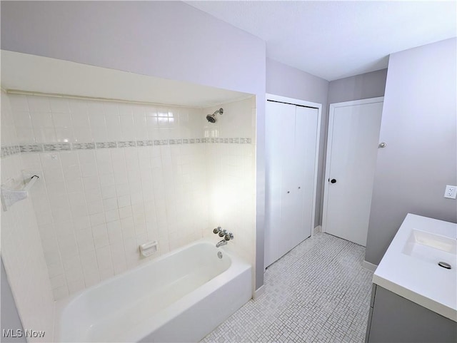 bathroom with tiled shower / bath, vanity, and tile patterned floors