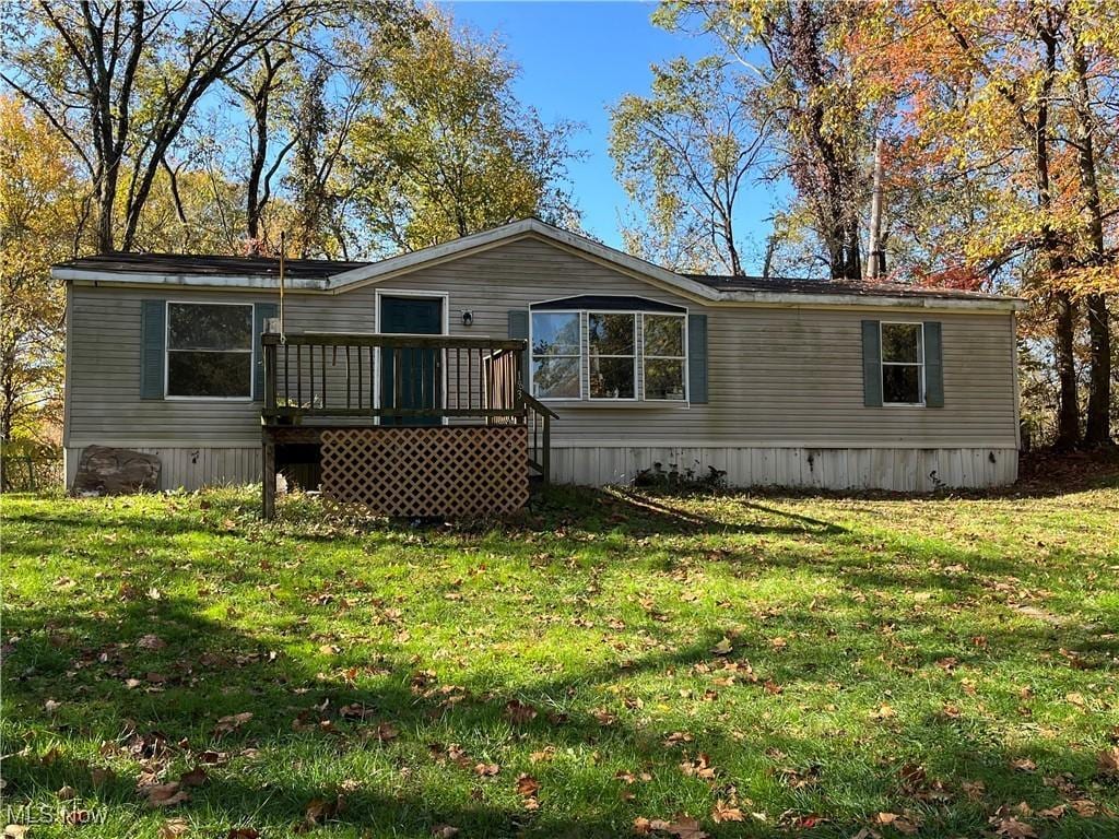 view of front facade featuring a deck and a front lawn