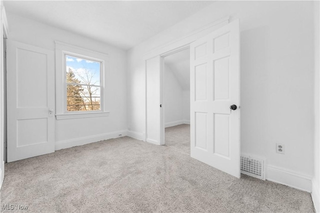 unfurnished bedroom featuring light colored carpet