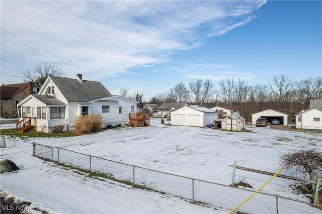 yard layered in snow with a shed