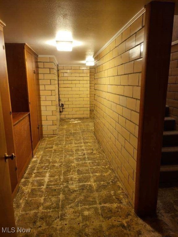 basement with crown molding and a textured ceiling