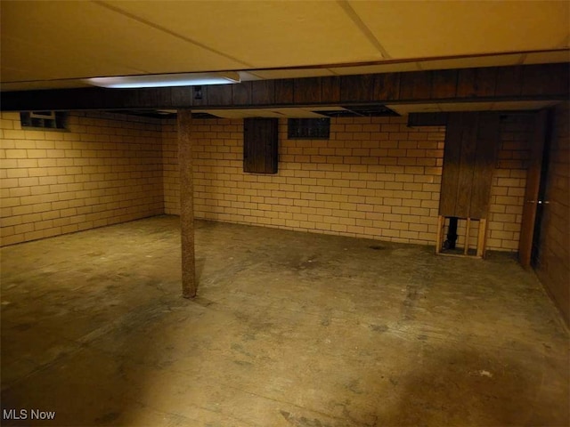 basement featuring brick wall