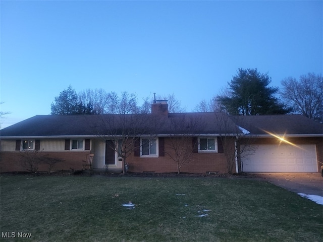 single story home with a garage and a front lawn