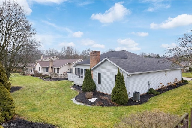 view of property exterior featuring a wooden deck, a yard, and central air condition unit