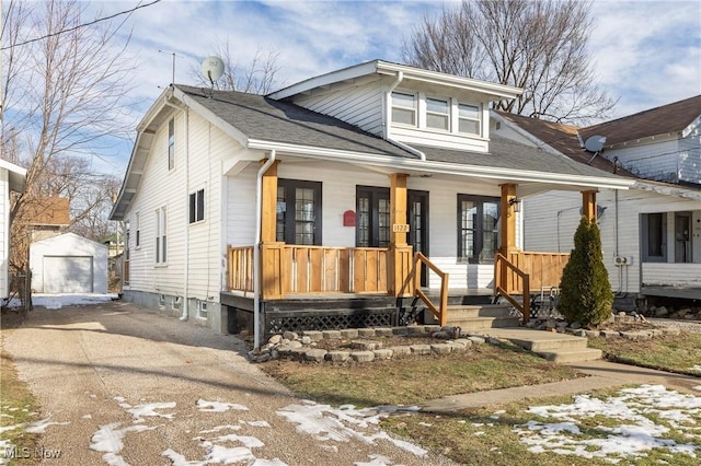 bungalow-style home with an outbuilding, a garage, and covered porch