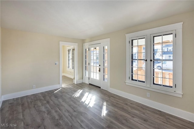 spare room with dark hardwood / wood-style flooring