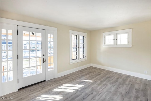 doorway to outside with light wood-type flooring