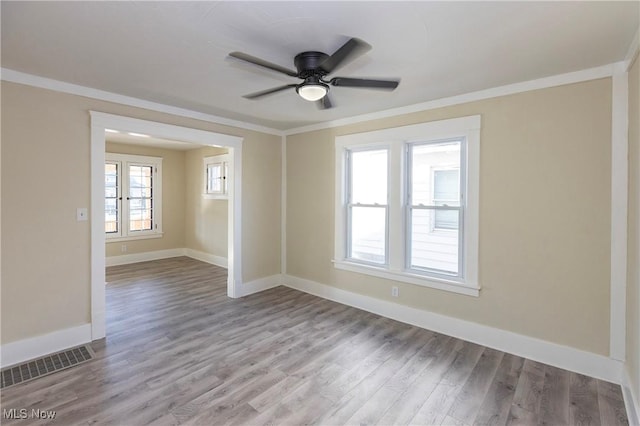 unfurnished room with light hardwood / wood-style flooring, ornamental molding, and ceiling fan