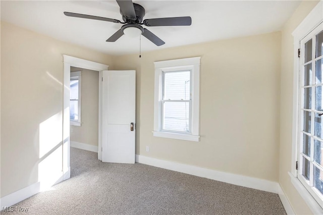 carpeted empty room with ceiling fan