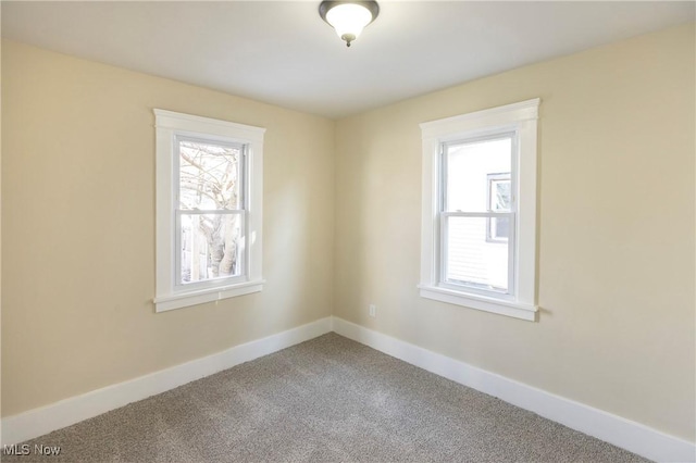 carpeted empty room with a wealth of natural light