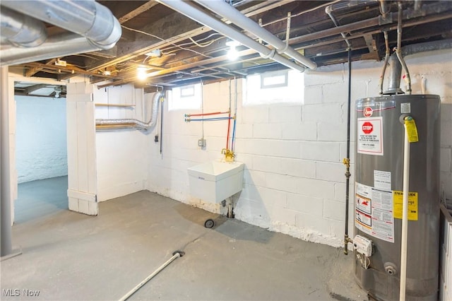 basement featuring sink and gas water heater