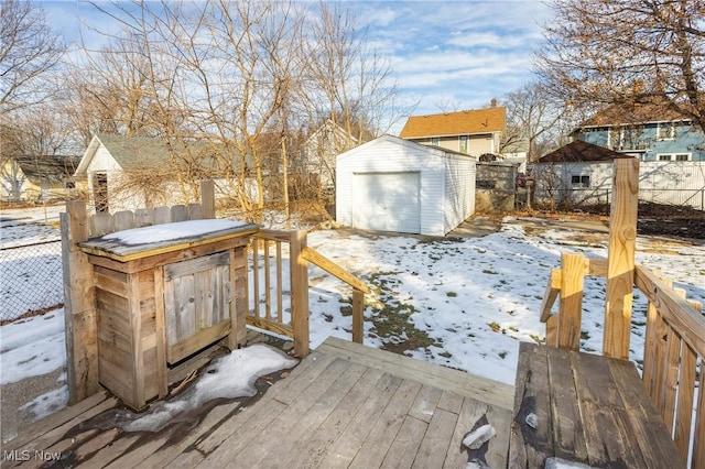 snow covered deck with a shed