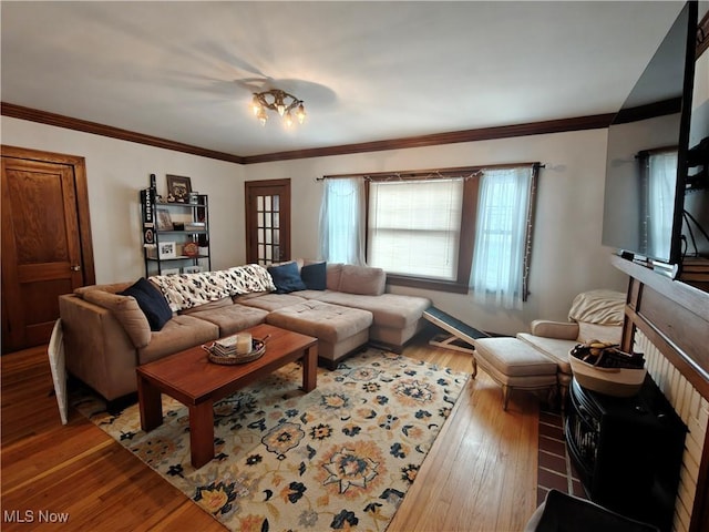 living room with light hardwood / wood-style flooring and ornamental molding