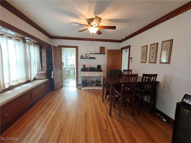 dining room featuring crown molding, light hardwood / wood-style floors, and ceiling fan