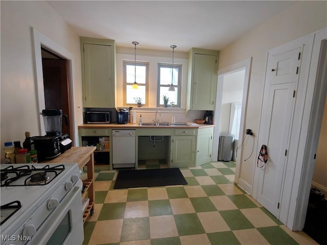 kitchen with pendant lighting, sink, white appliances, green cabinets, and butcher block counters