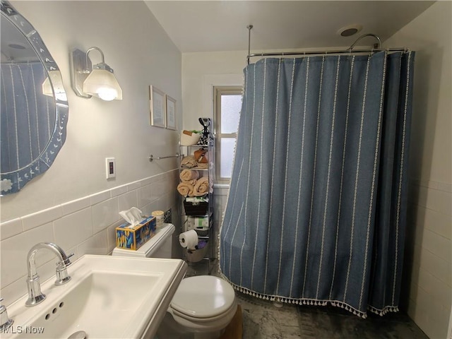 bathroom featuring tile walls, sink, toilet, and a shower with shower curtain